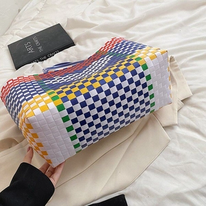 Close-up of a colorful checkered woven tote bag showing durable texture and large capacity