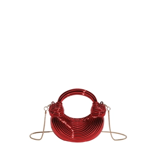 Detailed view of red acrylic crescent mini bag with ribbed texture and gold chain strap