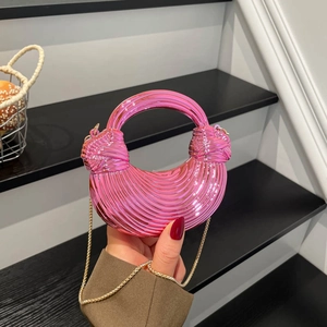 Metallic pink heart-shaped acrylic handbag with pleated texture and gold chain strap