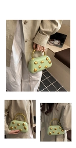 Detail of light green PU hard shell bag with irregular gold metal decor and chain strap