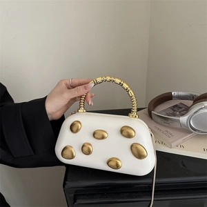 White hard shell box bag with gold pebble metal detail and chunky top handle for evening