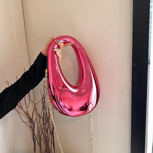 Metallic pink egg-shaped acrylic evening clutch bag with gold chain strap for women