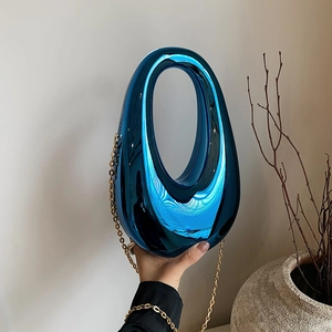 Mirror blue acrylic oval clutch bag with gold chain strap for luxury party wear