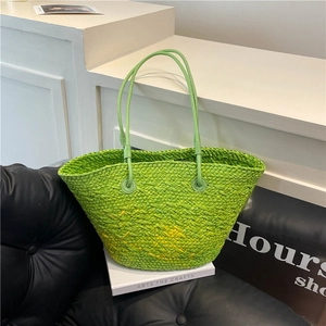 Grass green woven tote bag with leather handles and yellow gradient bottom for summer vacation