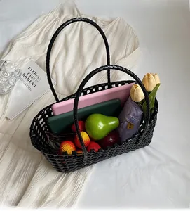 Spacious black woven hollow basket bag showing interior storage with daily essentials