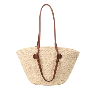 Summer woven tote bag with brown leather straps and textured beige straw finish