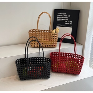 Detailed close-up of colorful hollow woven tote bags with flowers in modern setting