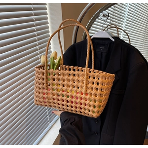 Detailed close-up of handmade woven tote bag in caramel brown with diamond weave pattern