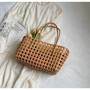 Detail of a brown hand-woven hollow knit tote bag with elegant rhombus mesh texture