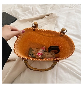Inside view of a woven tote bag showing daily essentials and retro bamboo handles