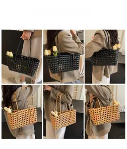 Detail of hand-woven hollow tote bags in black and light brown with shoulder straps