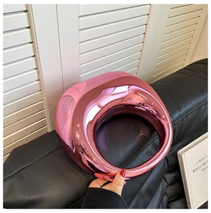 Detail of a pink mirror finish round evening bag with unique side striped texture