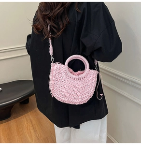 Detail of pink woven half-moon bag with chunky texture and drawstring closure
