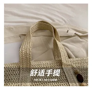 Detail of woven straw tote handle and wooden beads on a beach vacation style bag