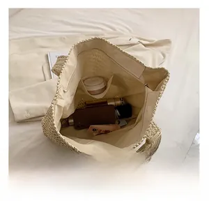 Internal view of the cream woven tote showing spacious lining and organized pockets