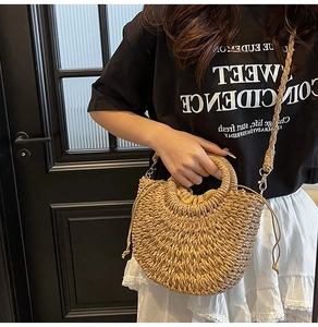 Detail of woven straw handbag with circular handles and drawstring lining for summer
