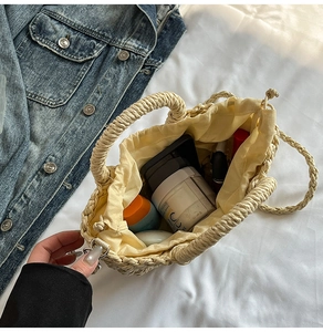 Close-up of beige woven bag with drawstring liner showing storage of daily essentials