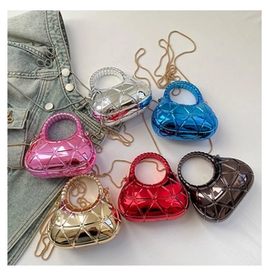 Macro view of mini acrylic evening bags with 3D geometric texture and metallic finish