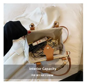Internal capacity of straw handbag with bamboo clasp showing phone and cosmetics