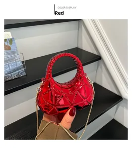 Macro shot of red metallic geometric acrylic evening bag with gold chain strap