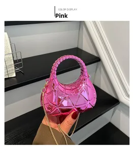 Detail of pink crescent acrylic box bag with geometric patterns and metallic chain strap