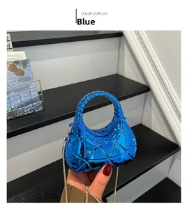 Close-up of a blue geometric acrylic mini bag with mirror finish and gold chain strap