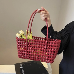Deep red woven tote bag in a minimalist style with long handles and white tulip decor