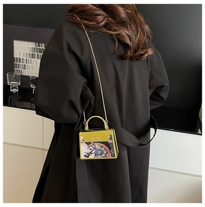 Mini acrylic party bag with colorful horse pattern and gold chain strap on model