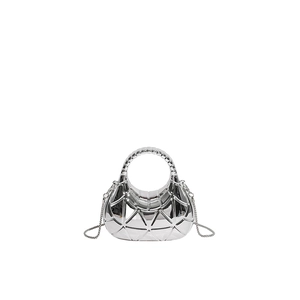 Macro shot of silver acrylic evening bag with 3D geometric texture and chain strap