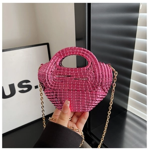Macro detail of hand-woven fuchsia metallic mini bag with golden chain strap