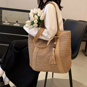 Large woven straw tote bag with fringe tassel charm for summer beach vacation