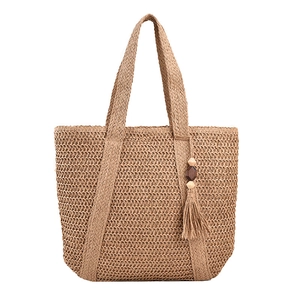 Large woven straw bucket bag with bohemian tassels and beads for summer vacation beach use