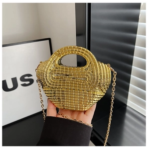 Detail of woven acrylic handbag with metallic gold finish and slim chain strap
