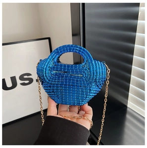 Detail of royal blue woven bead mini handbag with shiny finish and gold metal chain strap