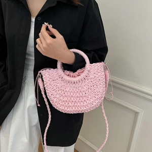 Pink hand-woven half-moon crossbody beach bag with top handle and drawstring liner