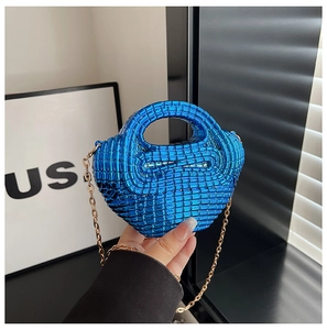 Detail of electric blue acrylic woven mini bag with gold chain and circular handle