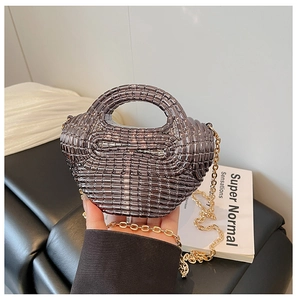 Detail of gunmetal beaded woven mini bag with detachable gold chain strap and top handle
