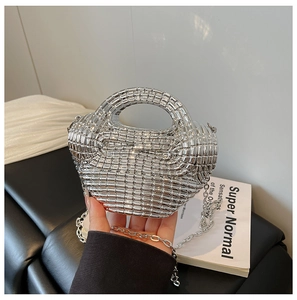 Detailed close-up of a silver woven metallic crescent bag with chain strap and top handle