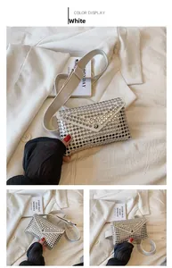 Detail of white punk belt bag with silver metal studs and adjustable shoulder strap