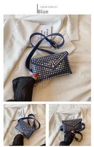 Detail of blue punk waist bag featuring silver metal rivets and envelope flap design