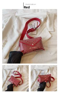 Detail of red punk envelope phone bag featuring silver studs and adjustable waist strap