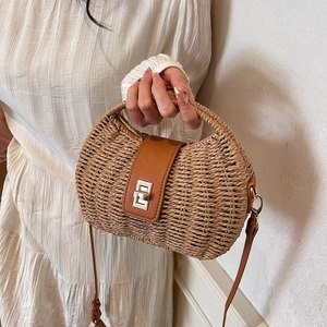 Bohemian crescent straw handbag with brown leather flap and silver twist-lock closure