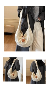 Detailed knit hobo bag in cream with brown leather buckle and soft wool-like texture
