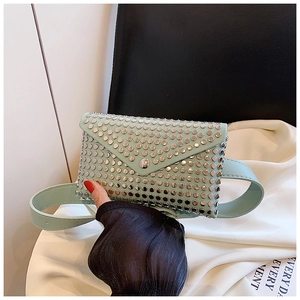 Detailed view of a mint green punk style waist bag with silver studs and belt attachment