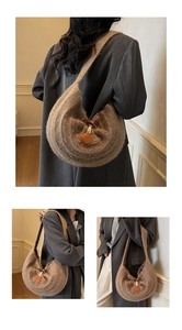Detailed close-up of brown knitted hobo bag with wavy texture and leather buckle accent