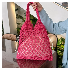 Detail of rose red hand-woven cotton tote bag featuring diamond crochet pattern and inner pouch