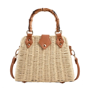 Straw bag with bamboo handle and brown leather straps for summer beach vacations