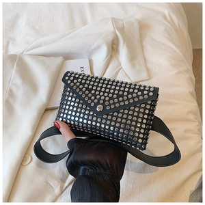 Detail of punk style black leather waist bag featuring silver studs and envelope flap design