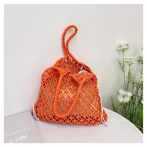 Detail of vibrant orange hand-woven cotton rope bag with a white drawstring inner pouch