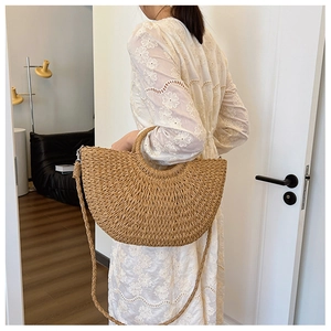 Vue détaillée du sac en paille demi-lune kaki avec poignée ronde et texture tressée